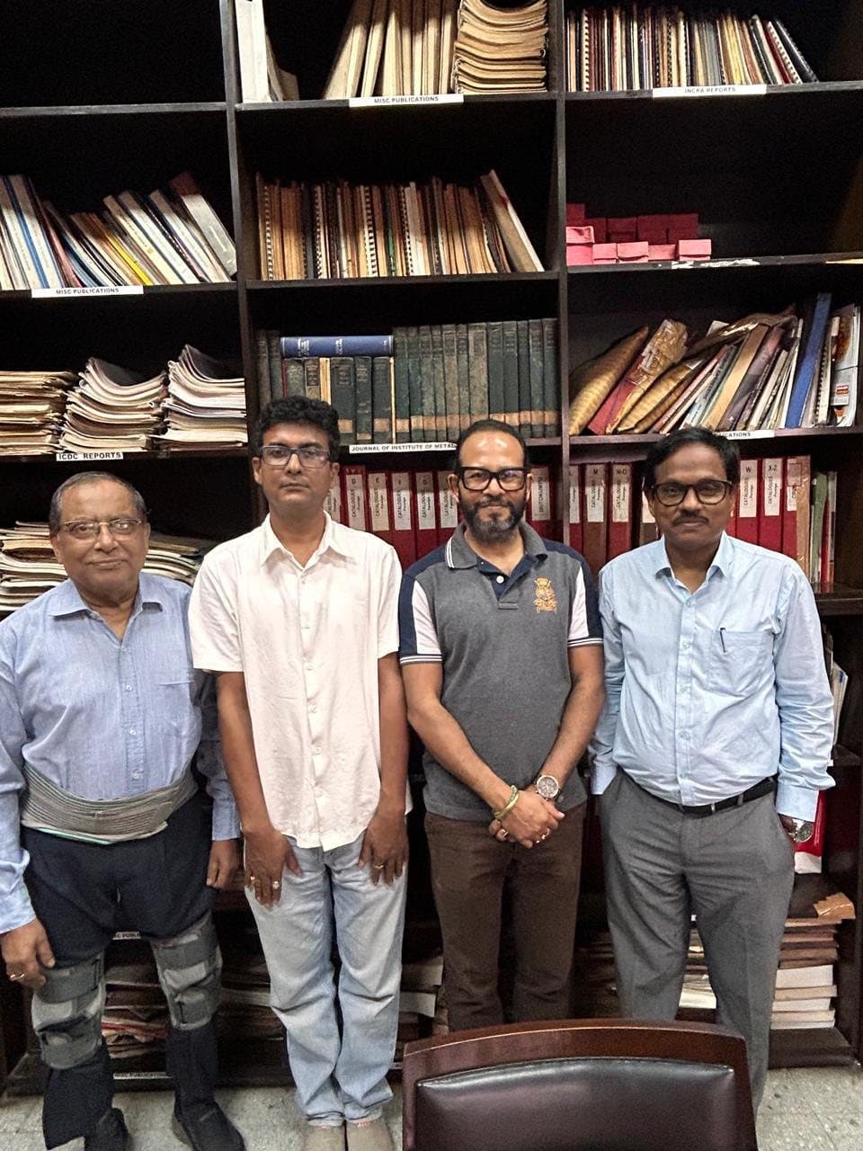 Prof. Manojit Ghosh with three colleagues in a library